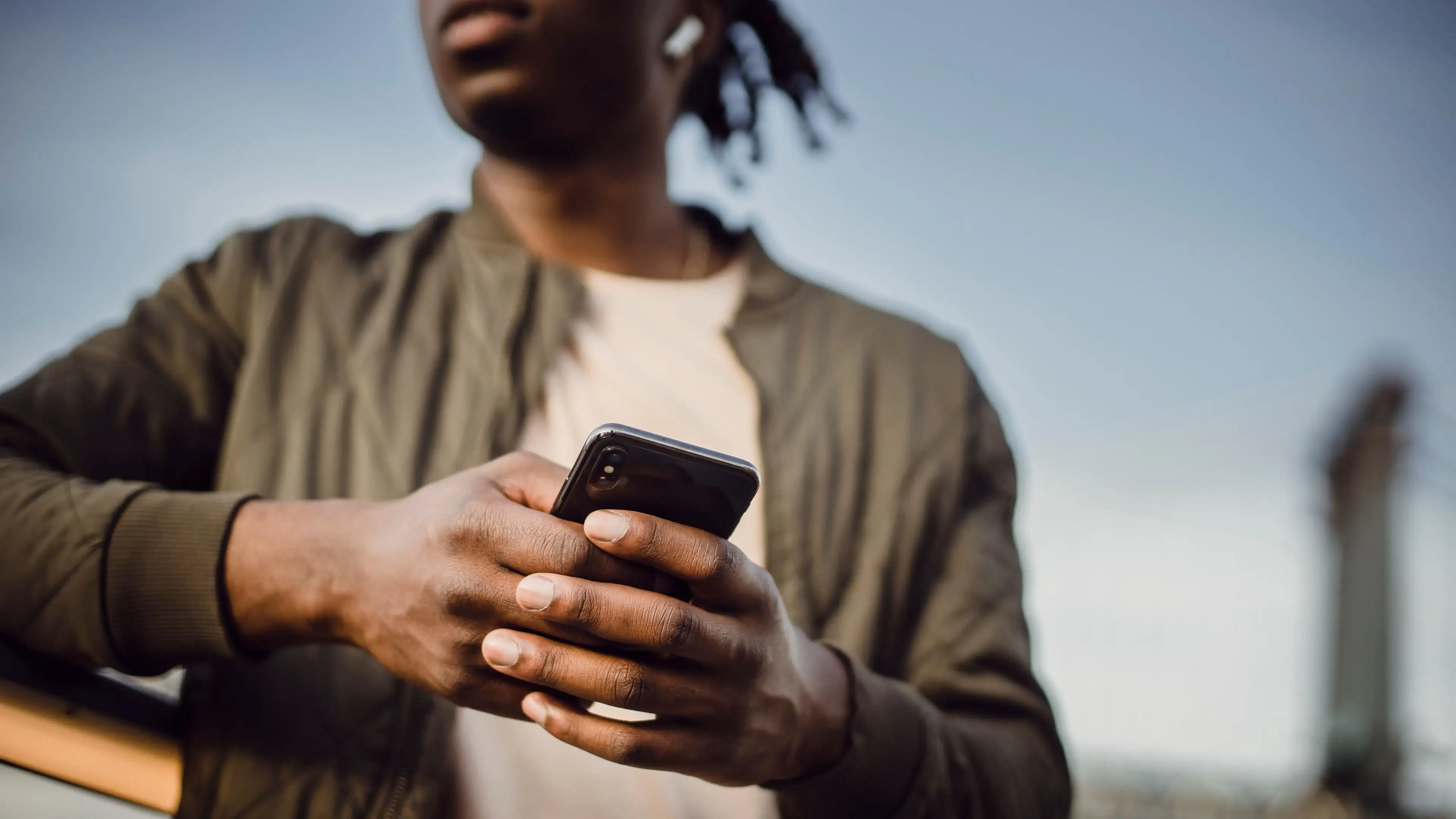 A man holding a smartphone in both hands